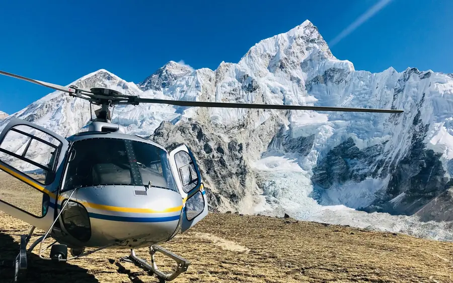 A helicopter landed at Kalapatthar with the Everest peaks behind
