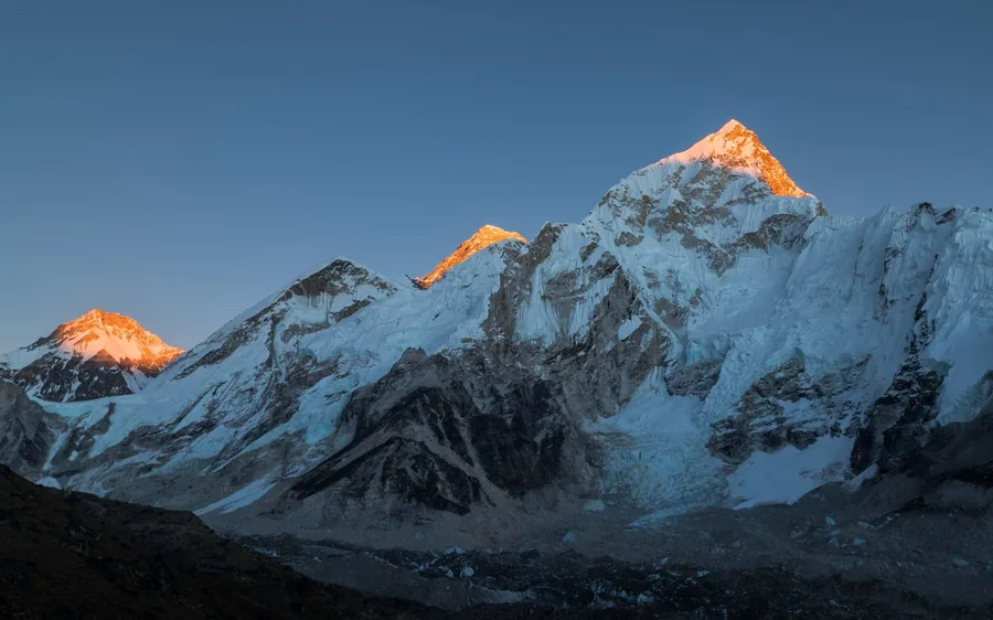 Mount Everest lit gold at sunrise above the Khumbu