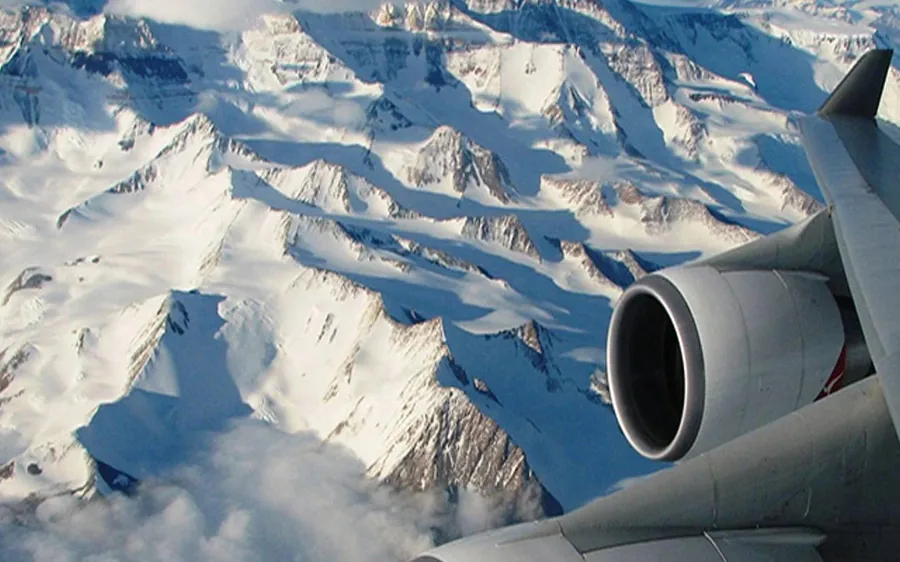 The wing of a mountain flight aircraft over the Himalaya